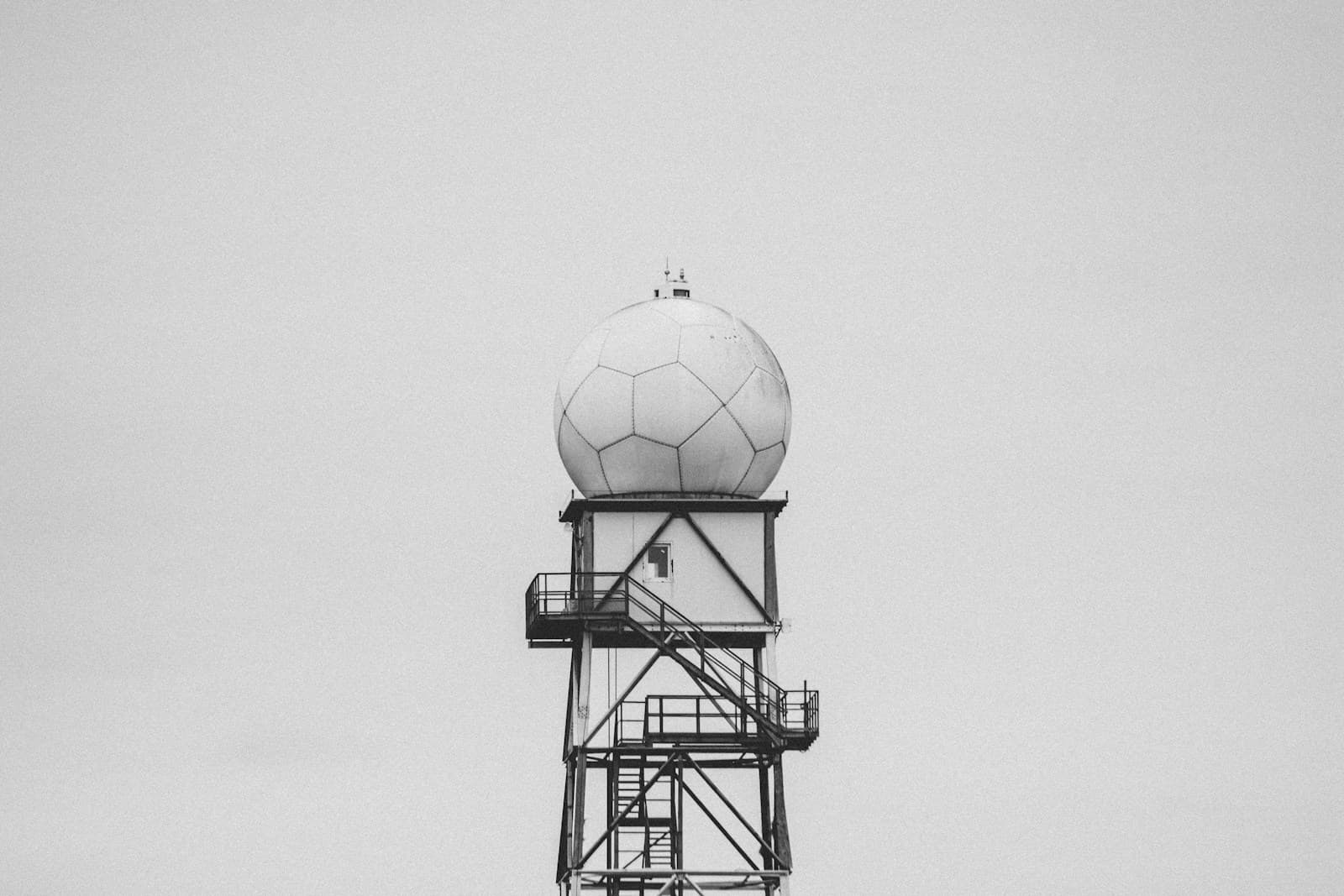 A white weather radar dome against a grey sky